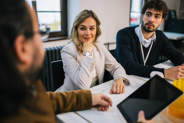 Young engineering team planning construction project indoors
