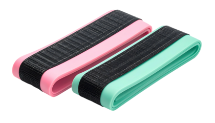 Two exercise resistance bands, pink and mint, lying next to each other on black