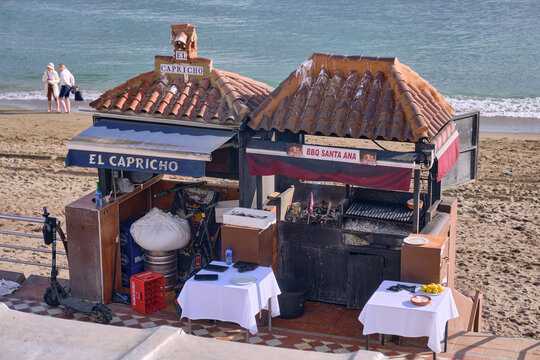 Beachfront Sea food Kiosk With BBQ Grill And Tables In Benalmadena Costa del Sol Spain Offering Food And Drinks To Tourists On A Sunny