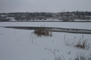 A snowy landscape with a river