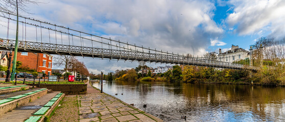 Fototapeta premium A view looking up the River Dee towards the Queens Park bridge in the city of Chester, Cheshire, UK