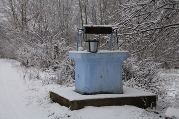 A snow covered outdoor toilet