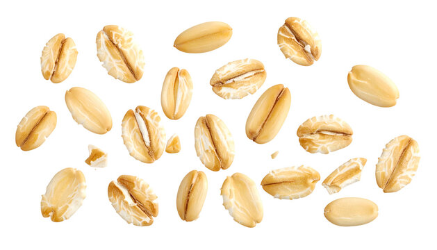 Isolated, close-up photograph of scattered, golden-brown rolled oat groats on black