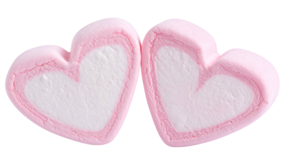 Two heart-shaped pink and white treats side by side against a black background