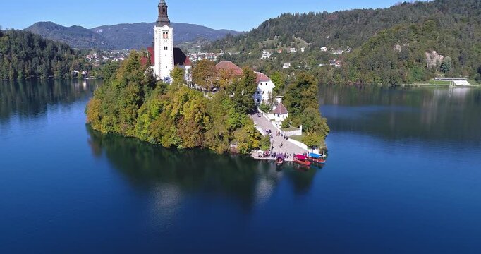 Aerial orbit around Bled Island and church on Lake Bled