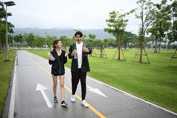 Casual fitness scene of friends walking in a park on a rainy day, combining exercise, friendship, and fresh air