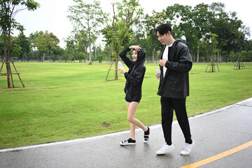 An Asian Friends Enjoy a Rainy Walk Together