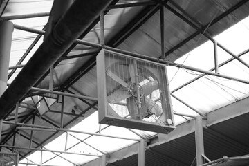 Industrial exhaust fan in black and white warehouse setting