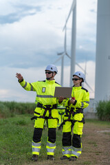 Fototapeta premium Engineers working on site in wind turbine farm, Wind turbines generate clean energy source, Eco technology for electric, industry environment.