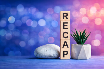 Recap word blocks displayed with a soft bokeh background representing summary, reflection, review process, business presentation, learning outcomes, and communication concept