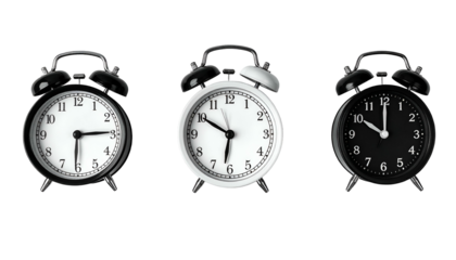 Three classic analog alarm clocks against a black background. Varying times shown
