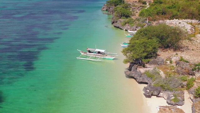 Aerial view of tropical shoreline with traditional boat