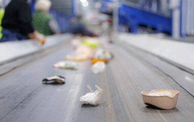 Conveyor belt with moving recyclable items in processing facility