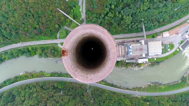 Aerial top-down view of industrial chimney and surrounding infrastructure