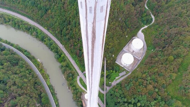 Vertical aerial descent along tall industrial chimney structure