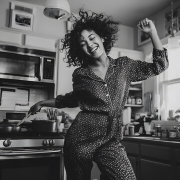 Happy Woman Dancing in Her Kitchen While Cooking in Pajamas, Candid Everyday Lifestyle, young woman in the kitchen
