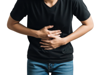 A person suffering from stomach ache, holding their abdomen in discomfort on a black background