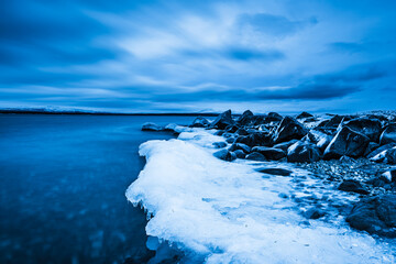 Ice along the shore of Lake Femunden in Norway creates a stark scene of nature in winter