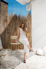 Joyful Woman Outdoors, Cheerful Woman Seated On Stones With Flowing Hair And Bright Surroundings