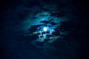 Fototapeta premium 8K photo of bright full moon and clouds on the night sky.