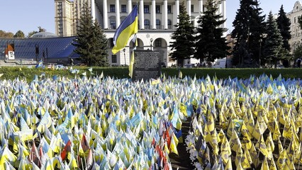 Many small blue-yellow flags with names of the dead war against russia. Memorial of the fallen...