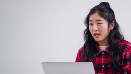 Asian woman reacting to laptop during online meeting. Remote work stress concept.
