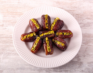 Date with pistachio filling on plate