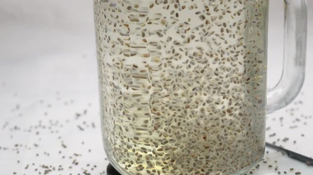Chia seeds water, infused drink contains water, soaked chia seed, help for hydration, healthy food for digestion, rich in omega-3 fatty acids and fiber. Selective focus.