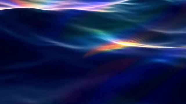 Wavy dark blue water surface reflecting iridescent rainbow colors and light, creating a holographic liquid metal effect.