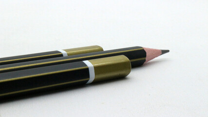 Black wooden pencils on white background