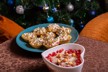Salad in tartlets on a plate and Chicken salad with pineapple and pomegranate