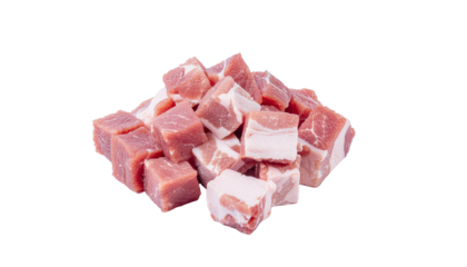 Pile of small pink and white cubes of meat or food product, irregularly shaped and stacked on a bright studio shot on white and transparent