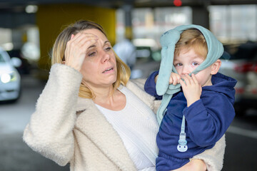 Stressed Mother Carrying Sick Toddler