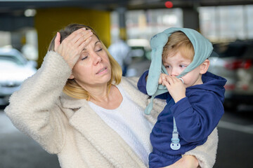 Overwhelmed Mother Holding Sick Toddler