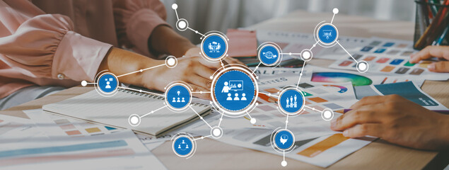 A dynamic workspace scene showing hands in collaboration, surrounded by colorful design resources and digital tools, highlighting creativity and teamwork in modern environments. Amity