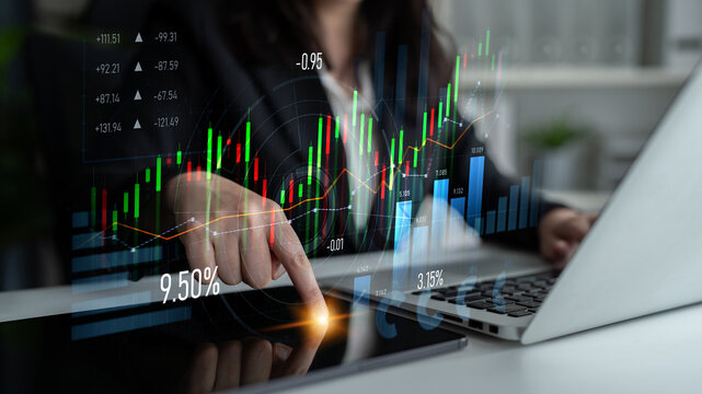 A focused businesswoman is analyzing stock market trends using a laptop with a financial overlay. The visual data displays growth metrics and statistical analysis in a modern office setup. Scalp - Powered by Adobe