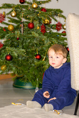 Toddler Sitting Near Christmas Tree