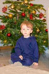 Toddler Sitting Before Christmas Tree