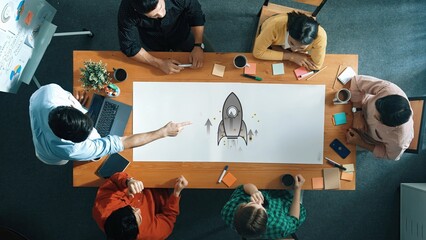A dynamic office meeting showcases a diverse team engaged in collaborative brainstorming. A rocket...