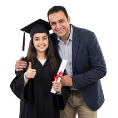 Proud father hugging young daughter wearing graduation gown and holding diploma while giving thumbs up