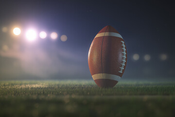 American football resting on green grass field under stadium lights, creating a dramatic atmosphere for sports enthusiasts and showcasing the excitement of the game