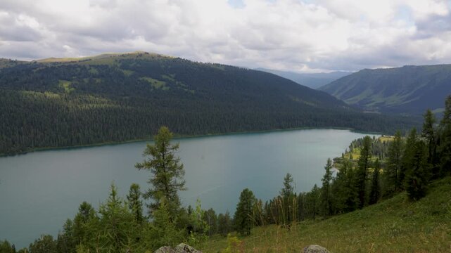 Landscape with mountains, clouds, and Lake Taimen. Altai, Russia. Timelapse