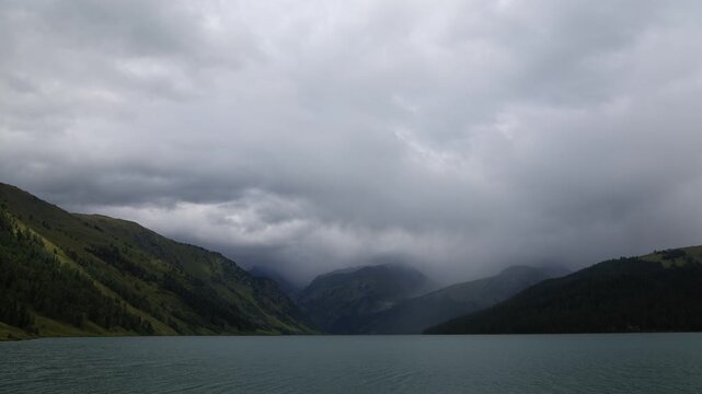 Landscape with mountains, clouds, and Lake Taimen. Altai, Russia. Timelapse