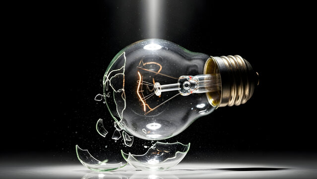 A light bulb made of fragile glass falling and cracking before glowing again, innovation failure and learning concept, dark background, dramatic light