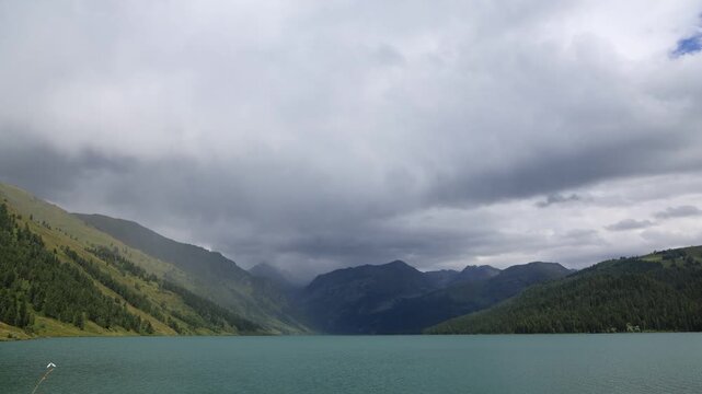 Landscape with mountains, clouds, and Lake Taimen. Altai, Russia. Timelapse