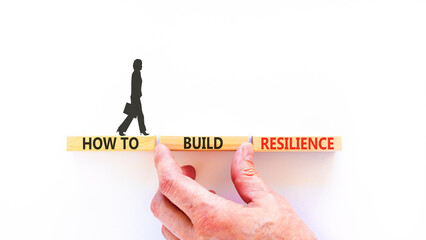 How to build resilience symbol. Concept words How to build resilience on beautiful wooden blocks. Beautiful white background. Businesswoman's icon. Business how to build resilience concept. Copy space