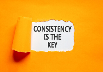 Consistency is the key symbol. Concept words Consistency is the key on beautiful white paper. Beautiful orange paper background. Business consistency is the key concept. Copy space.