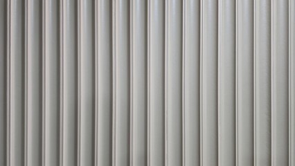 Obraz premium White Corrugated Metal Wall Texture Background. A close-up shot of a vertical, ribbed metal panel texture. The surface is clean, modern, and finished in a light grey or white color.