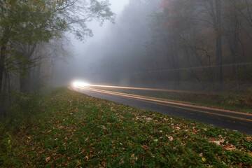 Car winding through foggy roads in the Smoky Mountains