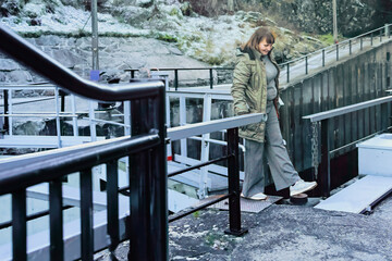 Everyday movement captured through an adult woman carefully stepping across a narrow path, expressing active ageing, balance, confidence, and slow living values within a realistic outdoor environment.